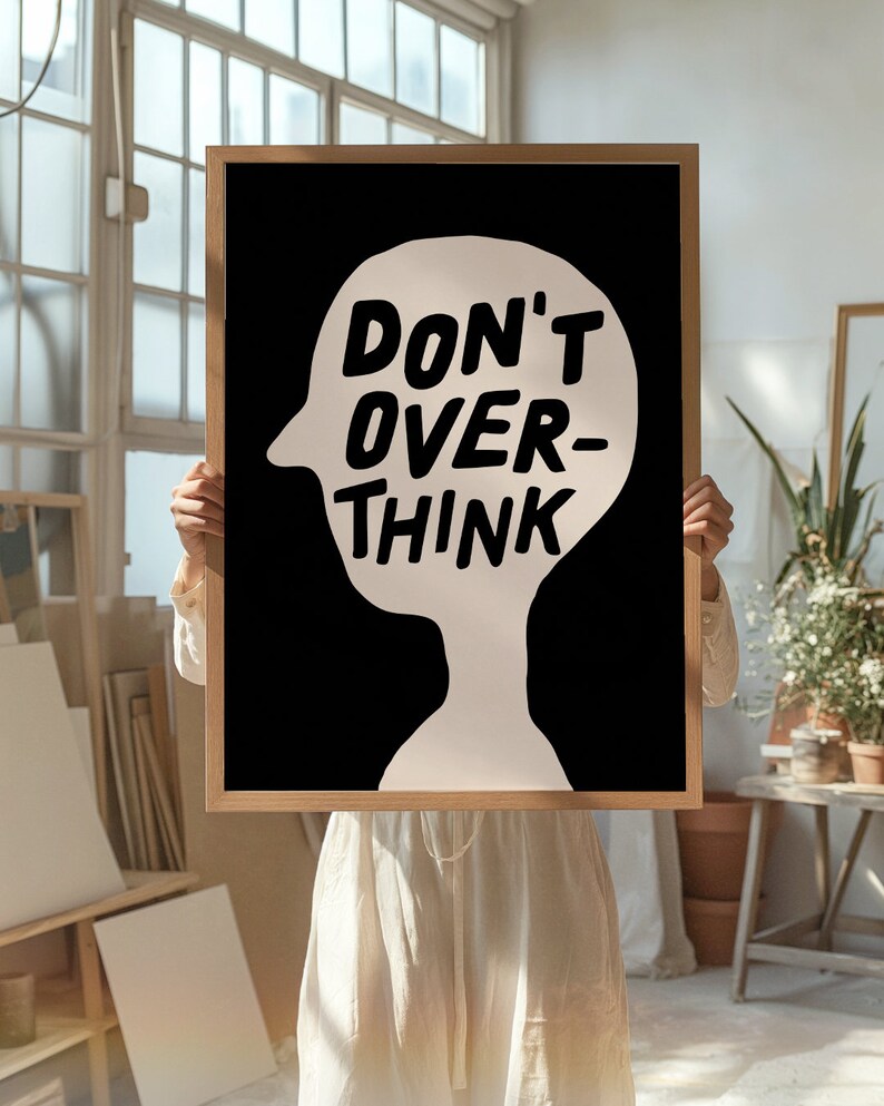 May include: A black and white poster with a white silhouette of a head and the text "DON'T OVER-THINK" in white.