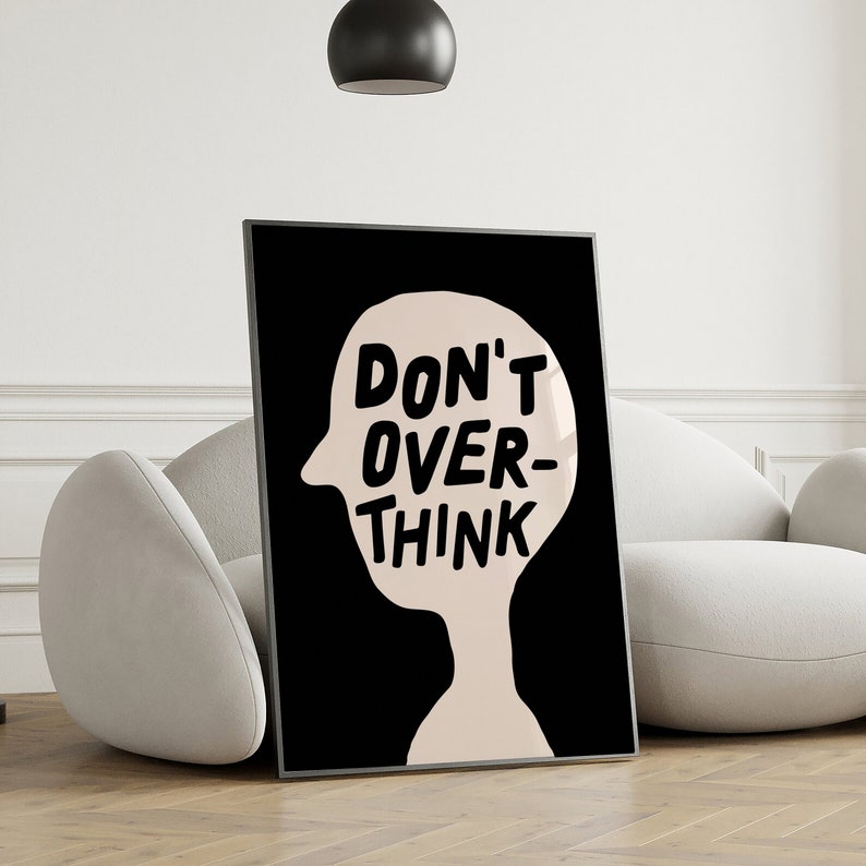 May include: Black and white poster with a silhouette of a head and the text "DON'T OVER-THINK" in bold, black letters.