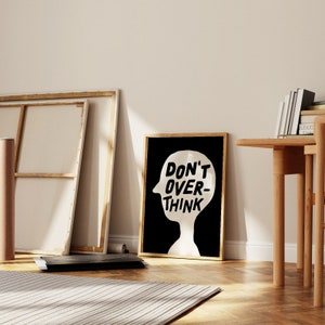May include: Black and white framed print with a silhouette of a head and the text "Don't Over-Think" in bold, white letters.