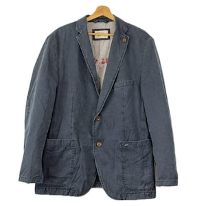 May include: A dark blue corduroy blazer featuring a notched lapel, two front buttons, and two patch pockets. The interior lining is light grey with the red text N.28 visible. The blazer is displayed on a wooden hanger against a white background.