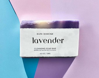 May include: A lavender-colored soap bar with a white label that reads "Bath Bohème lavender Cleansing Soap Bar Barre de Savon Nettoyante 4.5 oz / 128g"