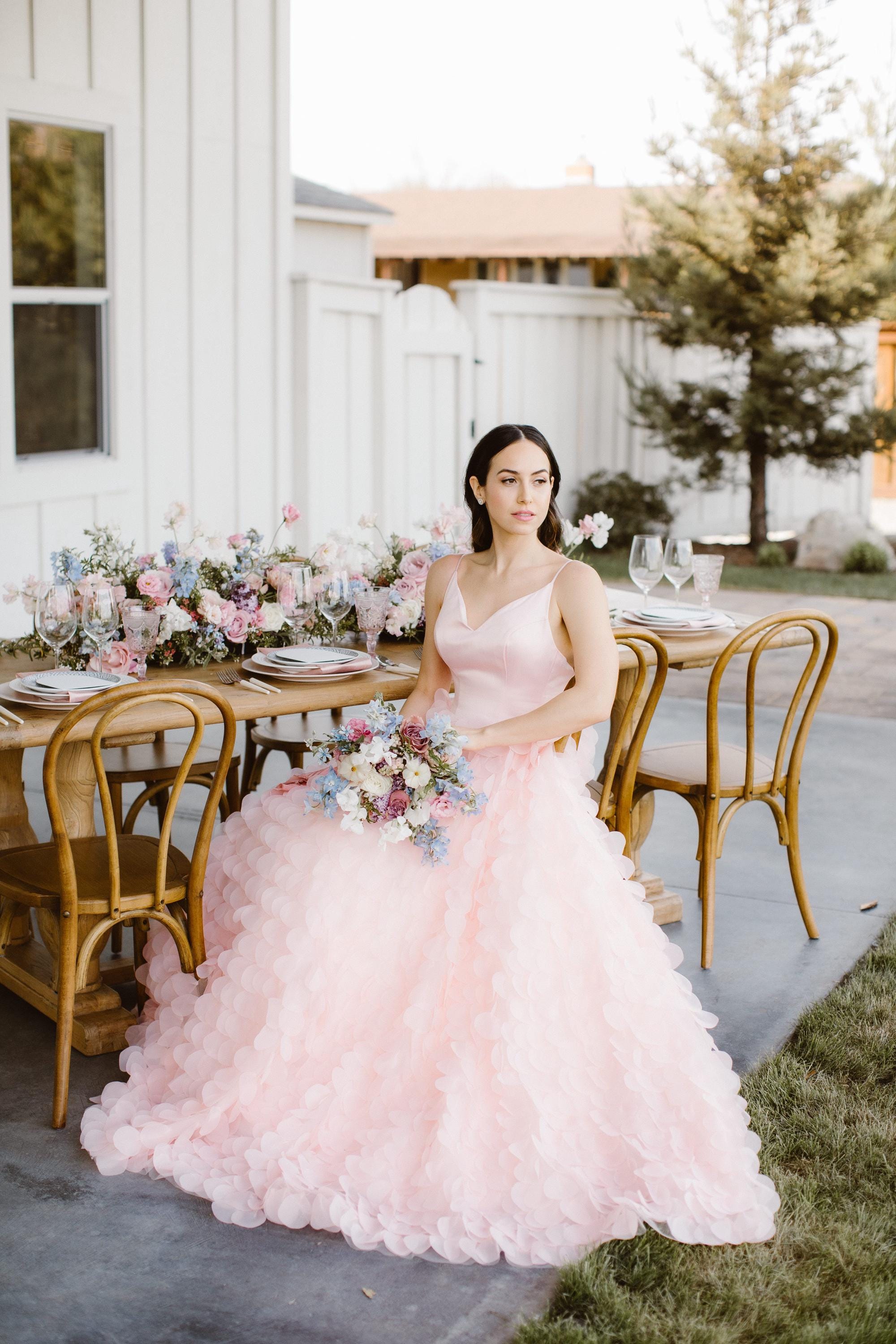 petal pink wedding dress  The Rachel : blush pink, petal-soft, and impossibly romantic. A  walking bouquet moment.,  Haylo Was Her Name : classic princess energy  with the sweetest modern touch.,  Wingardium: a little