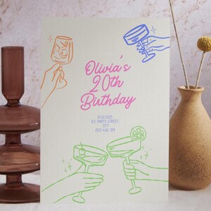 May include: A white card with a neon pink and blue design. The card says "Olivia's 20th Birthday" and has a drawing of two hands holding up glasses of cocktails. The card also includes the date, address, and phone number for the event.