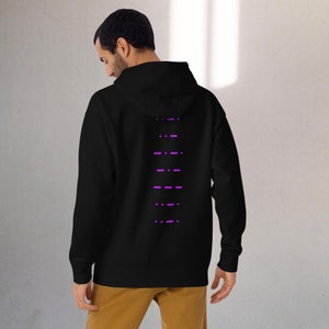 May include: Black hooded sweatshirt with a vertical row of purple dashes on the back.