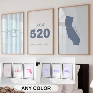 May include: Three framed prints with wooden frames. One features blue stripes and the text "University of California." Another says "DORM 520" with names below. The third shows a blue California outline. Below are smaller framed prints.