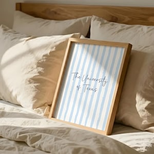 Elevate your aesthetic college dorm room decor with this custom blue preppy gallery wall set of three. Featuring a personalized university name poster, a floral initial monogram, and a delicate state map print. This digital download perfectly captures the highly sought after coastal granddaughter and grandmillennial interior design trends. An incredible printable high school graduation gift for teen girls, offering immense emotional utility and a beautifully cohesive living space sanctuary.