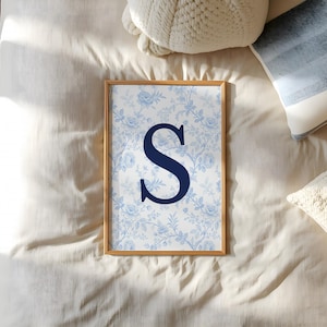 Blend athletic passion with grandmillennial elegance by styling this custom college dorm gallery wall set alongside our personalized sports jersey digital downloads. This aesthetic room decor features a blue preppy university, floral initial, and state map print next to custom football posters. By combining vintage floral charm with modern polished player suite designs, you create a highly unique printable gallery wall. This bespoke artwork delivers empowering emotional utility to any apartment.