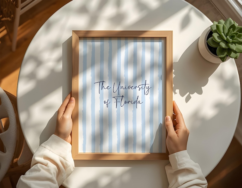 Discover the perfect meaningful alumni gift with this sophisticated blue preppy gallery wall set of three digital download. Showcasing a customized university poster, a beautiful floral initial monogram, and a detailed state map outline. Ideal for styling a professional home office or a cozy neutral living room. This printable personalized wall art delivers profound emotional utility and a deeply respectful personality, ensuring your interior design beautifully reflects your unique school pride.