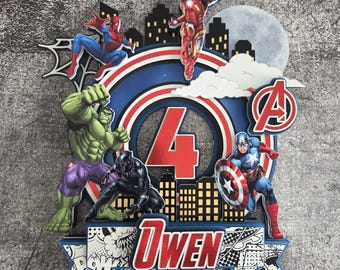 May include: A vibrant cake topper with Marvel superheroes such as Spider-Man, Iron Man, Hulk, Black Panther, and Captain America. The design incorporates a large number 4, the name "Owen", and the Avengers logo.