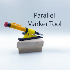 May include: A yellow and black parallel marker tool with a red tip. The tool is mounted on a wooden base. The text "Parallel Marker Tool" is printed above the tool.