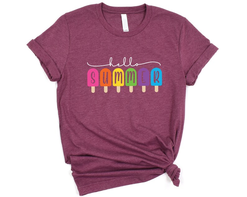 May include: A maroon t-shirt with the text "hello summer" in white lettering. The text is surrounded by a line of rainbow popsicles.