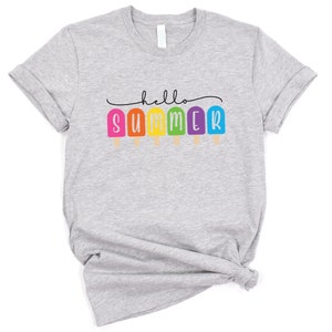 May include: Gray t-shirt with the text "hello summer" in a black script font. The word "summer" is spelled out with colorful popsicle graphics.