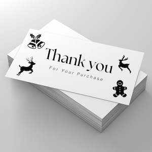 May include: A white thank you card with black Christmas icons, including reindeer, a gingerbread man, and bells with holly. The card reads "Thank you for your purchase."