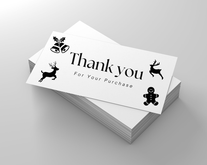 May include: A white thank you card with black Christmas icons, including reindeer, a gingerbread man, and bells with holly. The card reads "Thank you for your purchase."