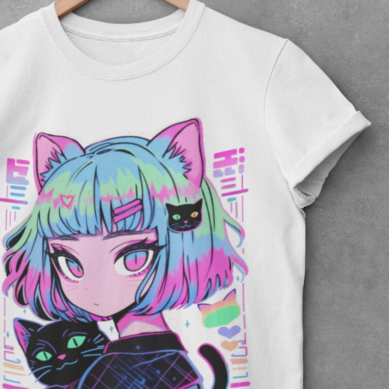 May include: White t-shirt with a colorful anime-style illustration of a girl with cat ears and a black cat. The girl has blue, pink, and green hair and is wearing a black and white shirt. The background is white with a rainbow and hearts.