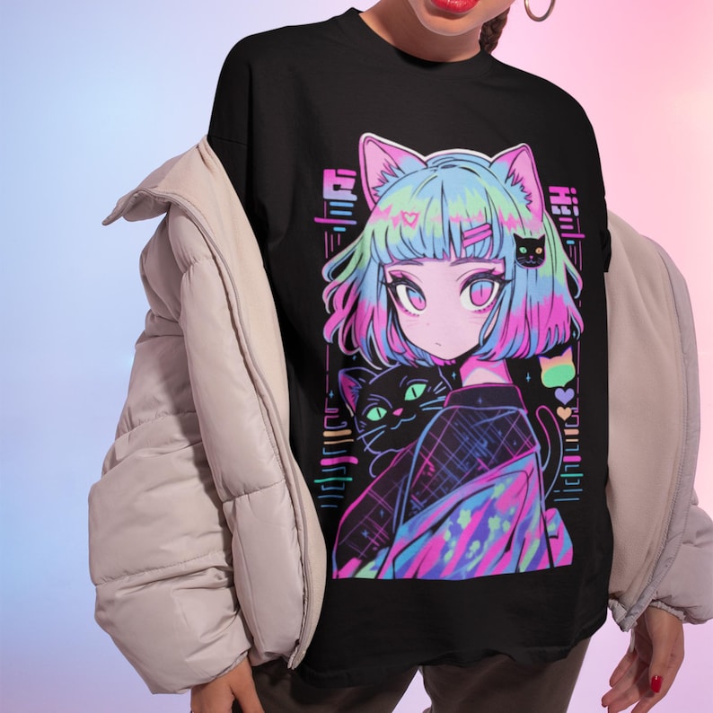 May include: Black t-shirt with a colorful graphic print of an anime-style girl with pink and blue hair holding a black cat. The girl is wearing a colorful patterned shirt and has a heart on her cheek.