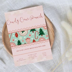 May include: A pink invitation for a Candy Cane Brunch, featuring a decorative band with Christmas ornaments, candy canes, and trees. The invitation includes event details and RSVP information. The overall theme is festive and holiday-oriented.
