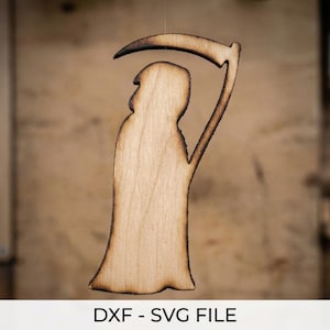 May include: A wooden cutout of the Grim Reaper with a scythe. The figure is light brown with darker brown edges, and is suspended against a blurred wooden background. The text "DXF - SVG FILE" is at the bottom.