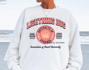 Trial of the Sun Queen Lightning Bug Sweatshirt - Licensed Nisha J. Tuli Merch - Artefacts of Ouranos Sweater - Queendom of Heart University