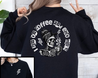May include: Black sweatshirt with a white graphic of a skeleton holding a cup of coffee. The text around the graphic reads "I run on coffee and emo music".