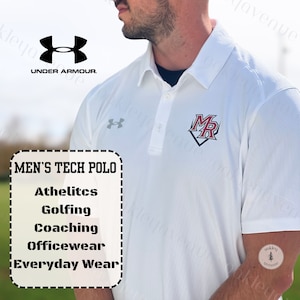 May include: White Under Armour tech polo shirt with a red and black "MR" logo on the chest. The shirt is labeled "Men's Tech Polo" and lists uses for the shirt, including athletics, golfing, coaching, officewear, and everyday wear.