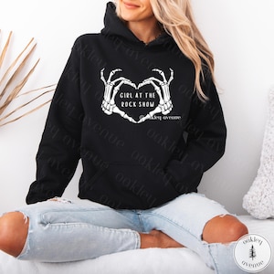 May include: Black hoodie with a white skeleton hand heart graphic and the text "Girl at the Rock Show" and "Oakley Avenue".