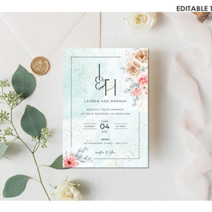 May include: A wedding invitation with a watercolour background in shades of blue and green. The invitation features a floral design with pink and peach flowers. The text on the invitation reads "Lauren and Hannah Request your company at their wedding celebration Sunday June 04 at 8am Hotel 123 Anywhere Street, Any City".