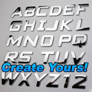 May include: A collection of shiny chrome alphabet letters and numbers, with the text "Create Yours!" in blue and white. The letters are in a bold, sans-serif font, ideal for customisation projects.