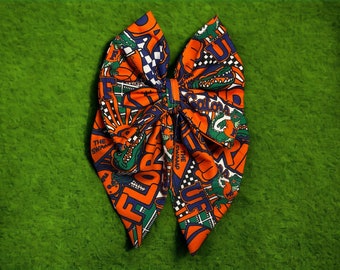 Lazo Fable de los UF Gators, UF, azul y naranja, Go Gators, lazo para la temporada de fútbol, lazo para fútbol universitario, lazo Fable, lazo con pinza de cocodrilo