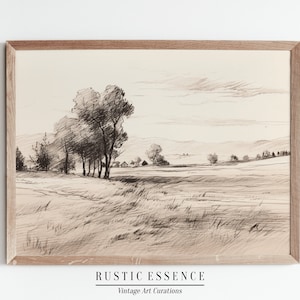 Peut inclure: Un dessin au crayon noir et blanc d'un paysage rural avec des arbres, un champ et un horizon lointain. Le dessin est encadré dans un cadre en bois brun clair. Le texte "RUSTIC ESSENCE Vintage Art Curations" est imprimé sous le cadre.
