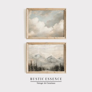Puede incluir: Dos pinturas de paisajes enmarcadas. La pintura superior representa un cielo nublado en tonos azul claro y gris. La pintura inferior representa una cordillera en tonos marr&oacute;n claro y gris. El texto "RUSTIC ESSENCE" y "Vintage Art Curations" est&aacute; debajo de las pinturas.
