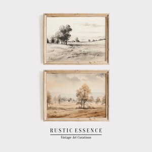 Puede incluir: Dos pinturas de paisajes enmarcadas en un estilo r&uacute;stico. La pintura superior es un boceto en blanco y negro de un campo con &aacute;rboles y una casa en la distancia. La pintura inferior es una acuarela de una escena similar con tonos marrones y beige c&aacute;lidos.