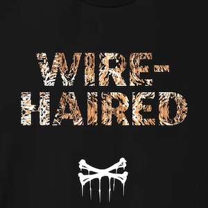 May include: Black t-shirt with a white graphic print of the text "WIRE-HAIRED" in a leopard print pattern. The graphic also includes a white skull and crossbones with dripping paint.