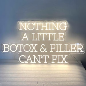 May include: White neon sign with the text "NOTHING A LITTLE BOTOX & FILLER CAN'T FIX".