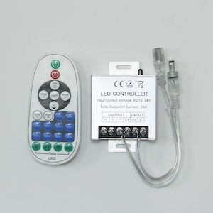 May include: An LED controller set, comprising a remote and a control box. The white remote features buttons for speed, light, and mode, alongside numbered buttons. The silver control box is labelled "LED CONTROLLER" and "Input/Output Voltage: DC12-24V".