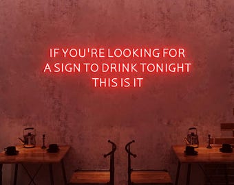 May include: Red neon sign on a pink wall with the text "If you're looking for a sign to drink tonight, this is it."
