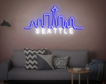 May include: A blue neon sign depicting the Seattle skyline with the Space Needle and the word "SEATTLE" in white neon.