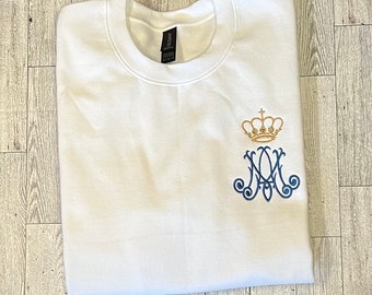 May include: White sweatshirt with a blue embroidered design of a crown and the letters "M" and "A".