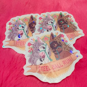 May include: A collection of holographic stickers featuring cartoon horses. Each sticker showcases two horses, one white and one brown, with the text "STEEL BALL RUN" on a banner. The stickers have a glittery, iridescent effect and are decorated with stars and flowers.
