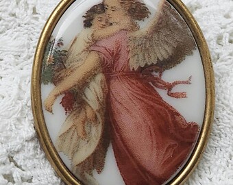 Broche vintage de lucita ovalada con forma de ángel de la guarda, querubín y niño