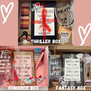 May include: Three boxes with different themes: "Thriller", "Romance", and "Fantasy". Each box contains a book, a drink, and other book-themed items. The boxes are decorated with hearts and the text "Blind Date w/ a Book".