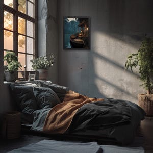 May include: A framed art print depicting a tranquil waterside scene with boats and a building illuminated by warm light. The artwork hangs on a gray wall above a bed with gray and orange bedding. A large window with plants sits to the left.