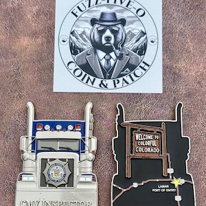 May include: A collection of collectible coins and a sticker. The sticker features a bear wearing a hat and sunglasses, smoking a pipe. One coin is a blue and silver CMV Inspector truck. The other coin is a black truck with a sign that says "Welcome to Colorful Colorado."