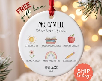 May include: A round white ceramic ornament hanging from a red ribbon. The text reads MS. CAMILLE thank you for... followed by six watercolor icons with captions: sun, books, apple, flower, rainbow, and pencil. It ends with LOVE, JACOB 2026.