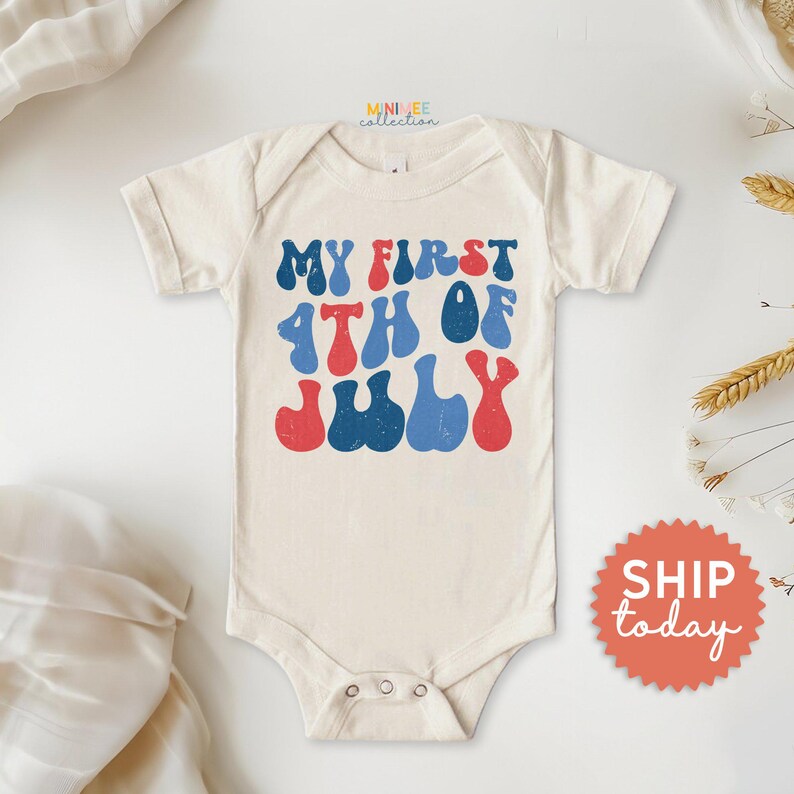 a baby bodysuit with the words my first fourth of july printed on it