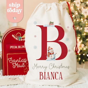 a white bag with a red letter and a snowman on it