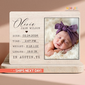 May include: A handmade wooden sign with the text "Welcome" in a playful font. The sign is painted white with a distressed finish, and features a decorative floral design in shades of pink and green. It measures approximately 12 inches wide.
