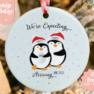 a christmas ornament with two penguins on it