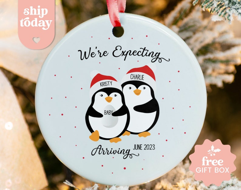 a christmas ornament with two penguins on it
