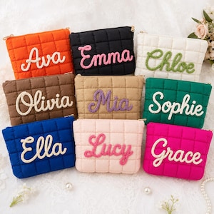 May include: A collection of nine rectangular quilted pouches in various colors, each featuring a name embroidered in a thick, textured yarn script. The pouches are orange, black, white, brown, tan, green, blue, light pink, and hot pink.